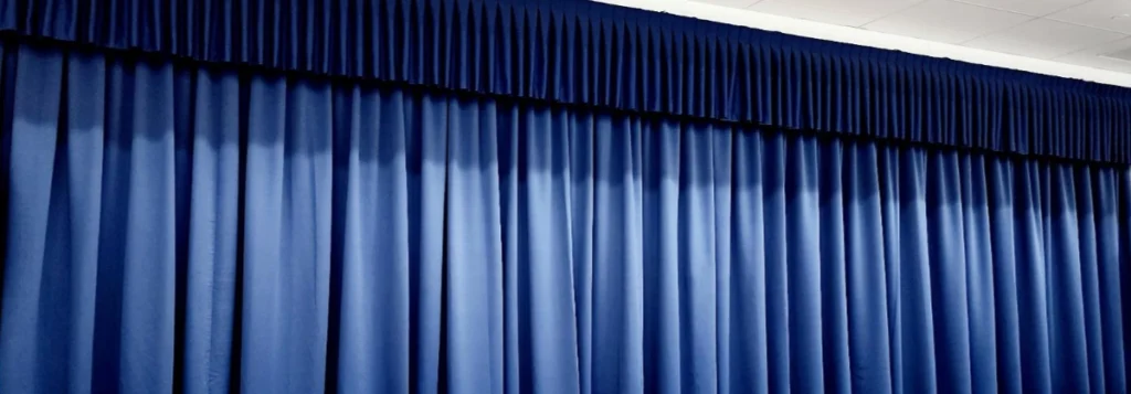a photo of blue curtains on a stage